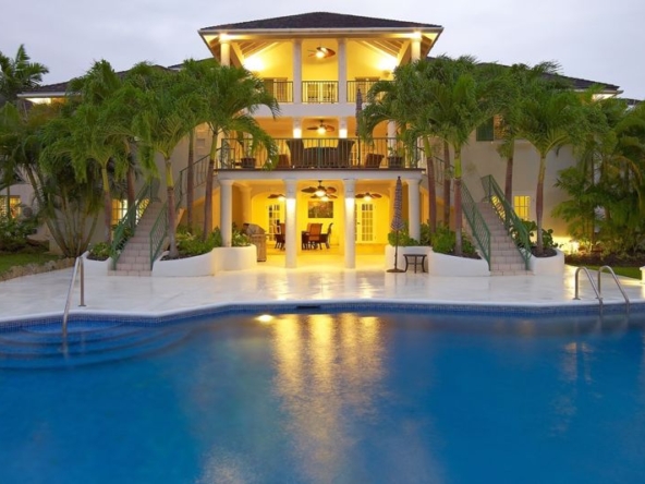 View of the pool and mansion at dusk, Aliseo Sandy Lane holiday villa