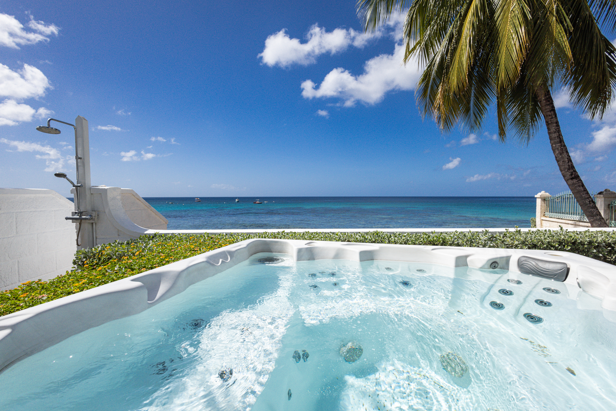 Barbados luxury beachfront villa view from jacuzzi in the garden with Caribbean Sea view beyond