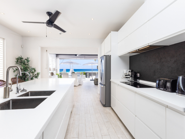 Barbados luxury modern beachfront villa, view from open design kitchen