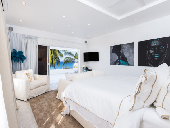 Barbados luxury modern beachfront villa view from master bedroom with extensive terrace and Caribbean Sea views beyond
