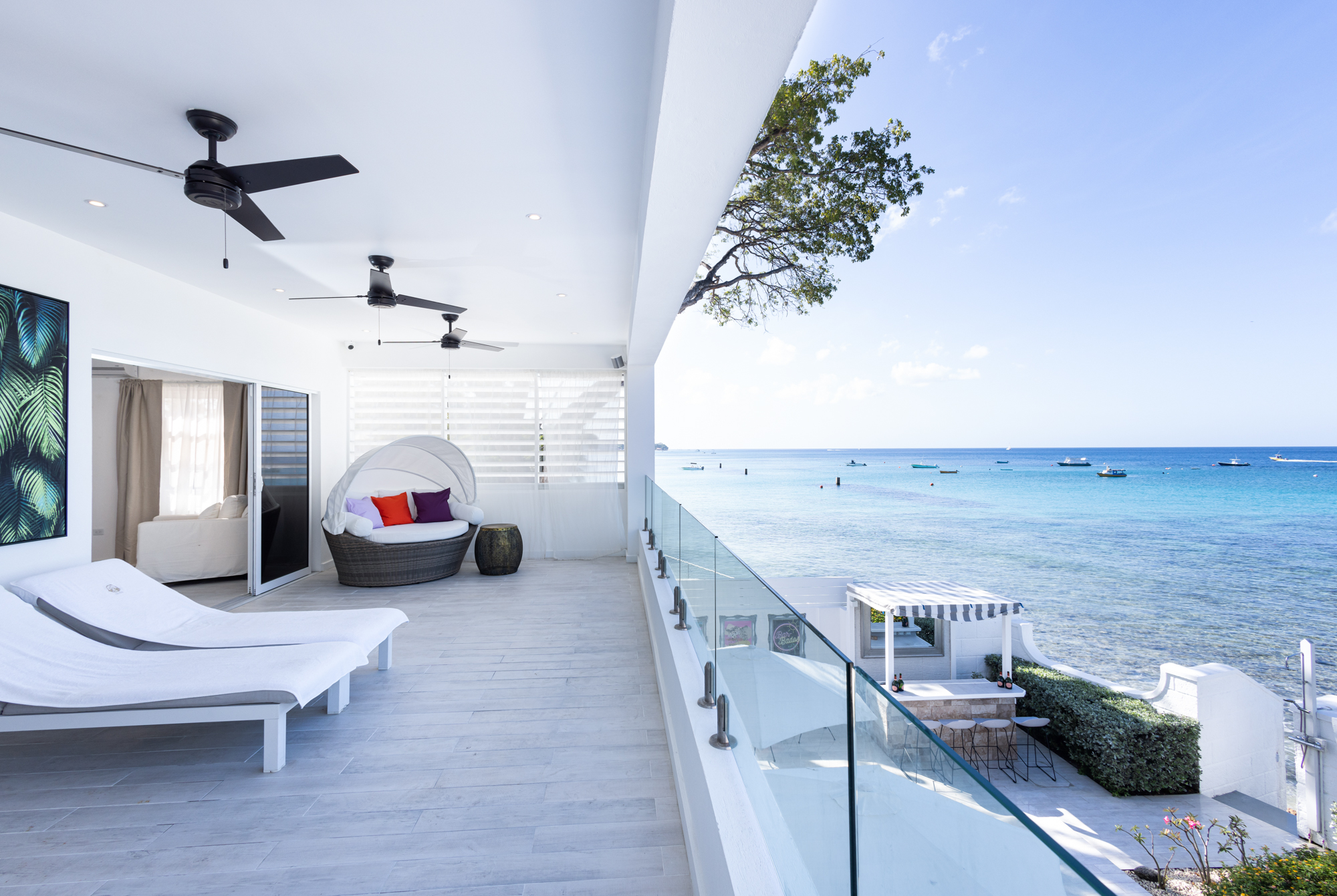 Barbados luxury modern beachfront villa view from master bedroom extensive terrace, to the gardens and Caribbean Sea views beyond