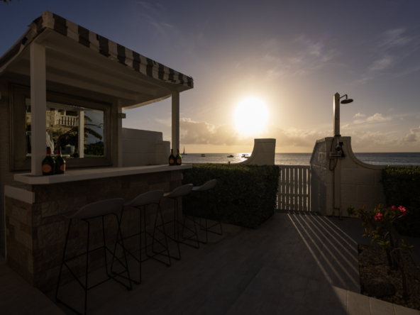 Barbados luxury modern beachfront villa beach bar at sunset