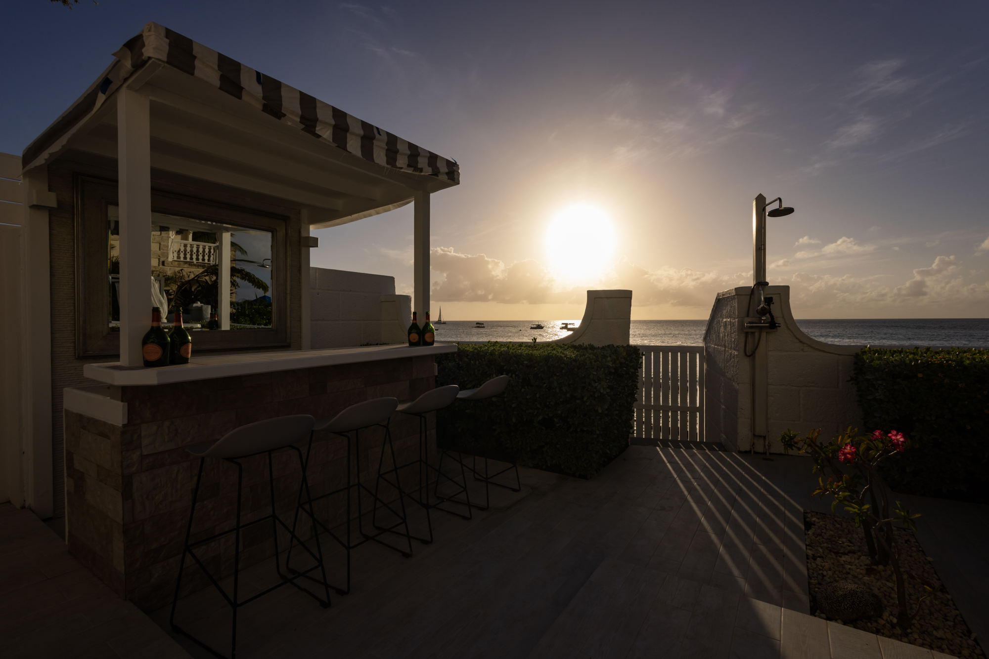 Barbados luxury modern beachfront villa beach bar at sunset