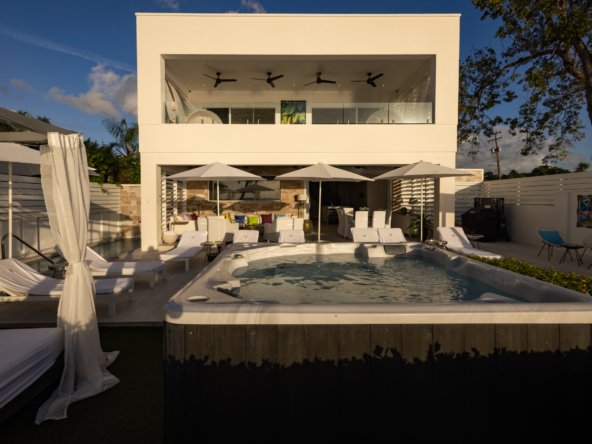 Barbados luxury modern beachfront villa garden with jacuzzi at caribbean majestic sunset