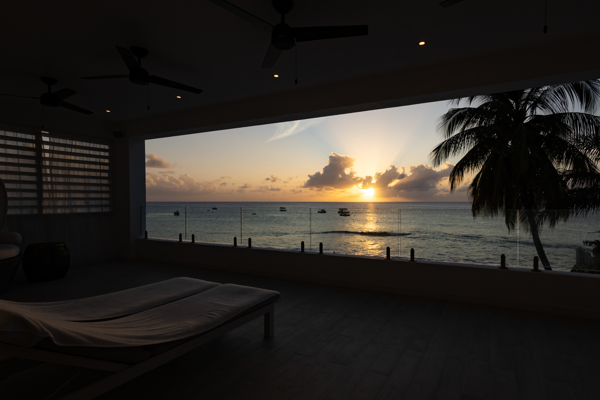 Barbados luxury modern beachfront villa balcony with Caribbean Sea sunset views