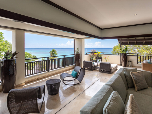 Balcony with ocean view and modern dark seating at luxury oceanfront villa in Barbados, Coral Cove Croswnest.