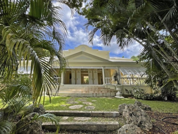 Traditional Caribbean-style family home surrounded by lush tropical gardens.