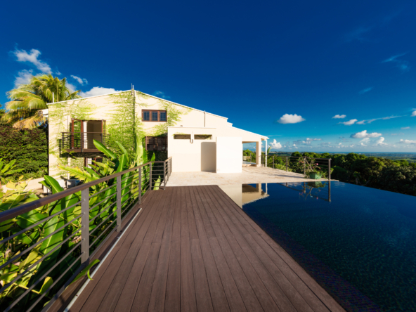 Explore Cloudreach, a unique rental home in Barbados featuring four bedrooms, panoramic views, and luxurious amenities set among a lush mango orchard.