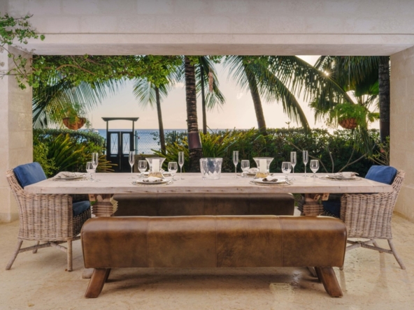 Outdoor seating and palm trees at luxury villa Barbados Wimoweh