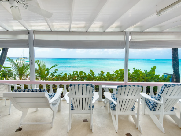 White chairs on terrace overlooking the ocean at relaxed beachfront villa, Belair, Mullins Beach.