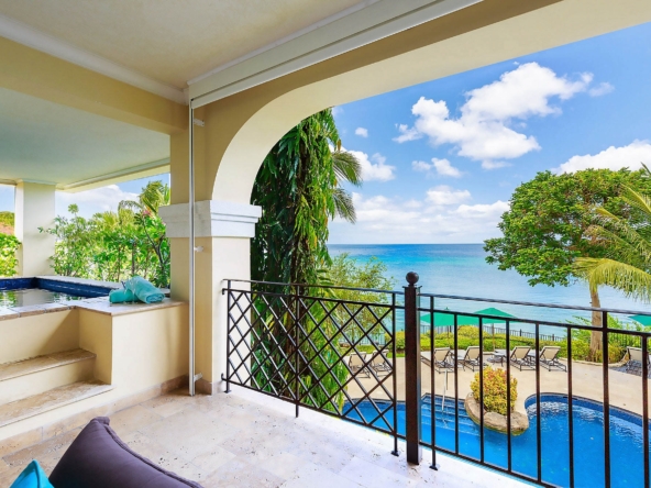 Balcony overlooking a pool and ocean at beachfront luxury villa, Sandy Cove 201