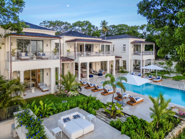 Exterior view of Exquisite Six Bedroom Beachfront Villa, swimming pool, and blue sky.