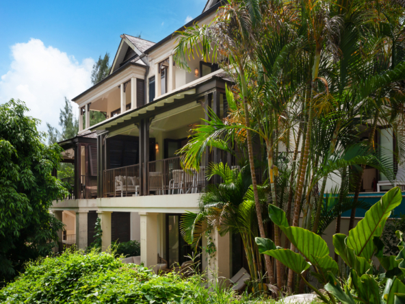 Image showcasing the elegant exterior of an exquisite 3-bedroom townhouse at Apes Hill, surrounded by lush tropical gardens and serene greenery.